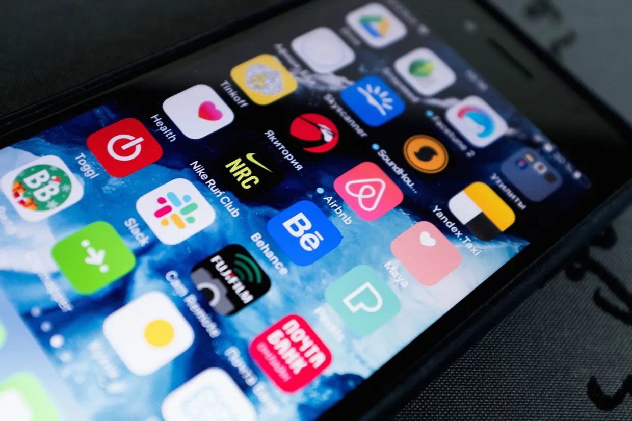 App Development Service — A smartphone home screen filled with mobile apps